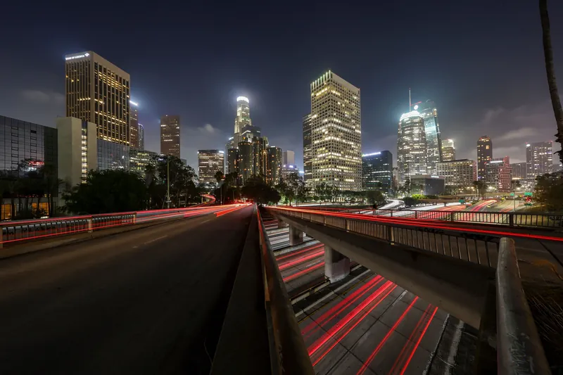 Stunning long exposure of Los Angeles downtown skyline at night with light trails.