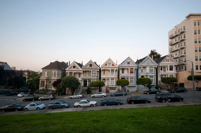 A row of the famous Painted Ladies houses in San Francisco, captured at dusk.