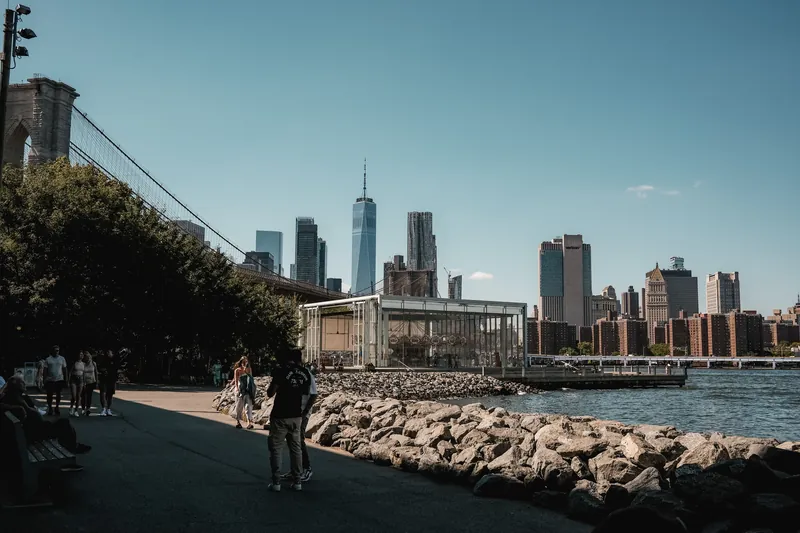 A picturesque scene of Brooklyn Bridge with the New York City skyline in the background, highlighting urban beauty.