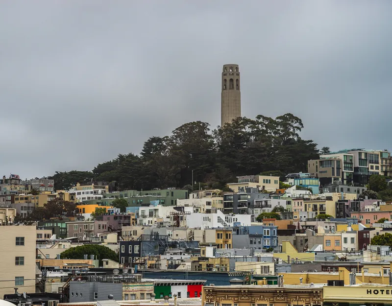 Scenic view of Coit Tower overlooking colorful buildings in San Francisco.