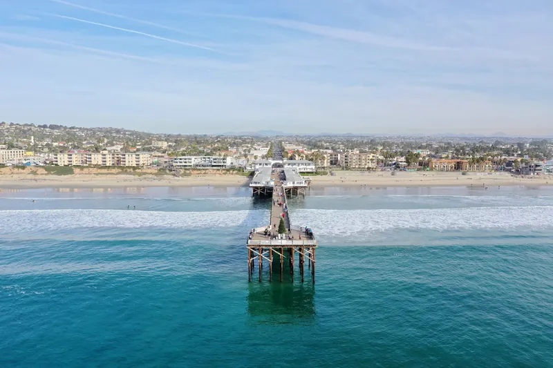 Stunning aerial view of Pacific Beach Pier overlooking the ocean and coastline in San Diego, California.
