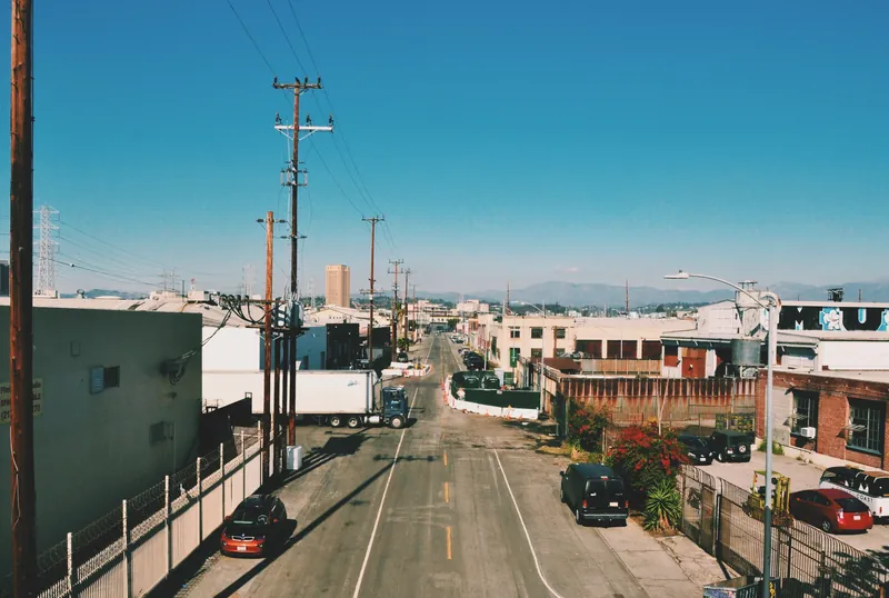 Aerial street view of an industrial area in Los Angeles, showcasing buildings and road intersection.