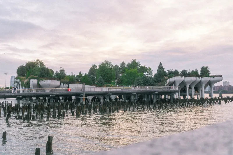 Scenic photo of Little Island park on the Hudson River in New York City at dusk.