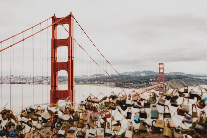 View of Golden Gate Bridge in San Francisco with focus on love locks in the foreground.