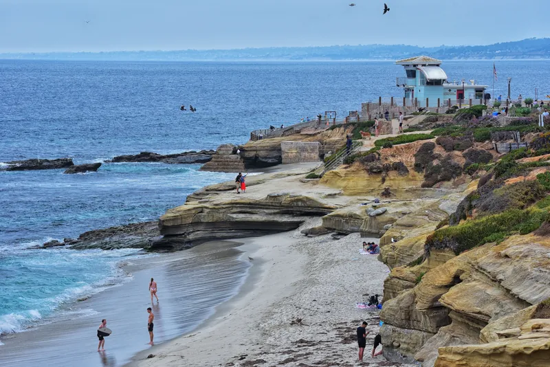 People enjoy a sunny day at the scenic La Jolla Cove in San Diego, California.