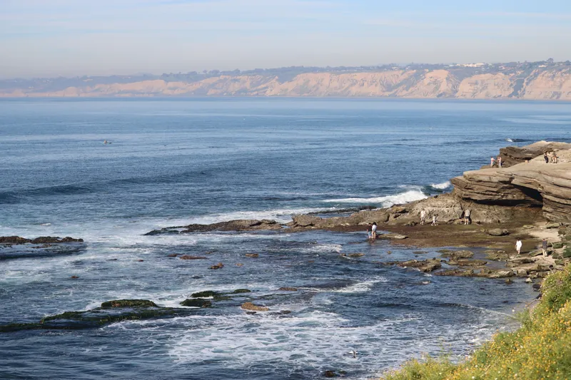 Explore the stunning coastline of La Jolla with ocean waves and rocky shores.
