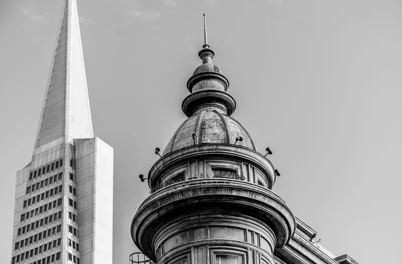 A striking black and white photo of classic and modern architecture creating a captivating urban contrast.