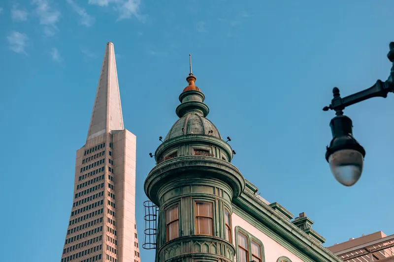 Iconic Transamerica Pyramid and historic architecture under blue skies in San Francisco.