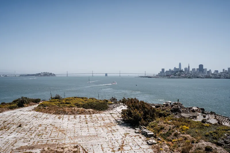 Stunning panoramic view of San Francisco skyline across the bay with Alcatraz Island and Bay Bridge.