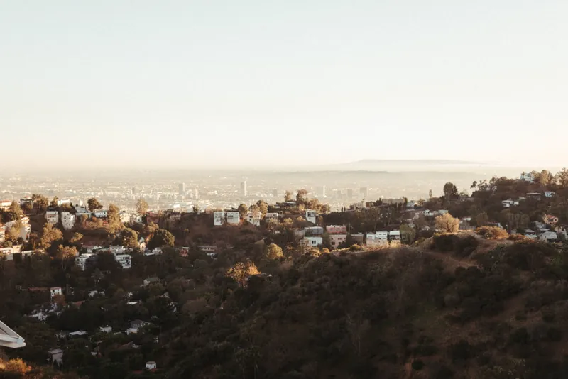 Stunning aerial view of Los Angeles hills with a sprawling cityscape in the background.