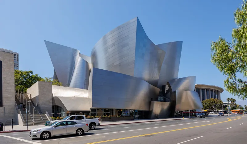 Modern architecture of the Walt Disney Concert Hall in Los Angeles under clear blue sky.