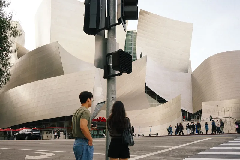 Modern city scene with iconic architecture and diverse pedestrians.